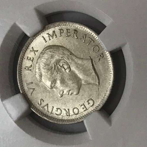 1942 SA Union shilling NGC graded AU 58 - Cracked die through neck variety