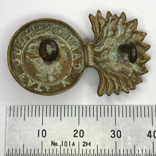 Great Britain Royal Northumberland Fusiliers collar badge, left side, lugs