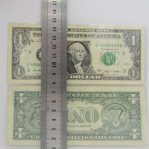 Pair of USA dollar bills with numbers that read the same in reverse