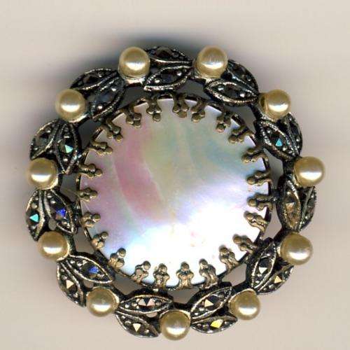 Antique brooch with mother of pearl center
