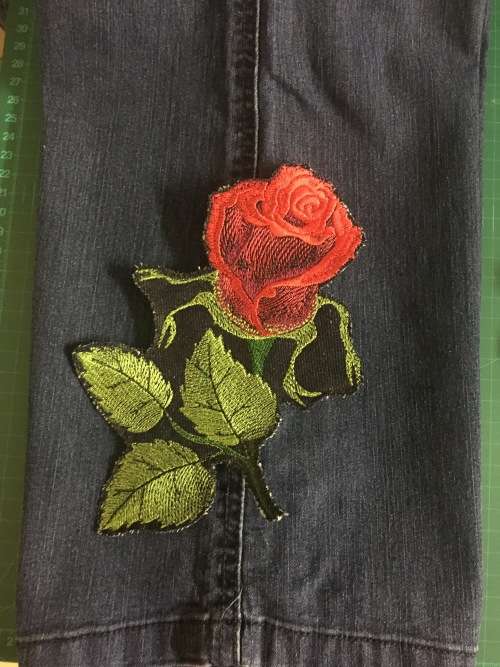 Red and green rose bud badge patch