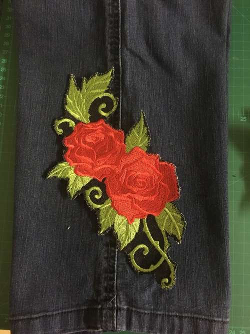Red and green baroque rose badge patch