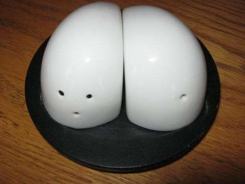 CUTE SET OF SALT AND PEPPER POTS WITH BLACK WOOD BASE
