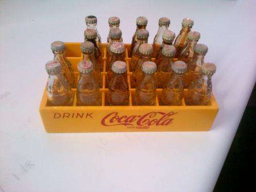 22 Glass coke bottles with plastic crate