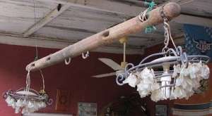 A vintage wooden yoke hanging light made with recycled glass chards