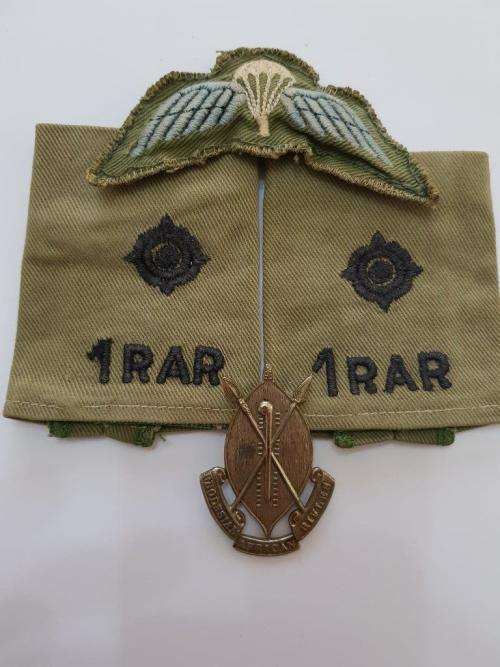 Rhodesia 1 RAR rank epaulets, padded Parachute wing and RAR cap badge missing lugs.