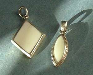 TWO VINTAGE GENUINE IVORY PENDANTS ,SET IN STERLING SILVER