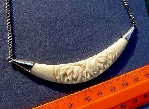 CARVED ELEPHANTS, PENDANT STERLING SILVER AND IVORY. ON SILVER CHAIN.VINTAGE BUT AS NEW.