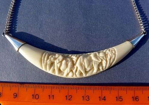 CARVED ELEPHANTS, PENDANT STERLING SILVER AND IVORY. ON SILVER CHAIN.VINTAGE BUT AS NEW.