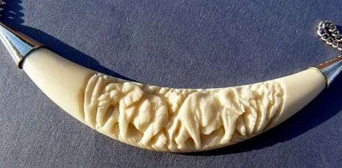 CARVED ELEPHANTS, PENDANT STERLING SILVER AND IVORY. ON SILVER CHAIN.VINTAGE BUT AS NEW.