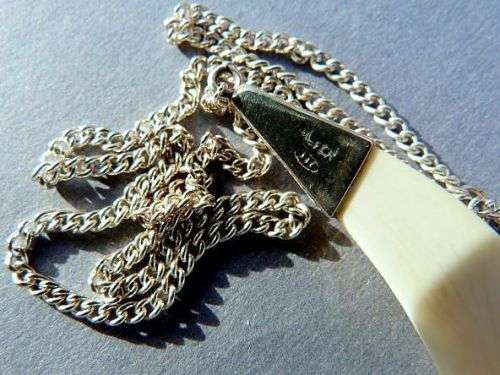 CARVED ELEPHANTS, PENDANT STERLING SILVER AND IVORY. ON SILVER CHAIN.VINTAGE BUT AS NEW.