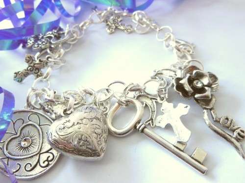 Silvertone Charm Bracelet with Cross, Dolphin, Clover and Heart Charm