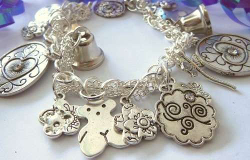Silvertone Charm Bracelet with Bell and Floral Type Charms