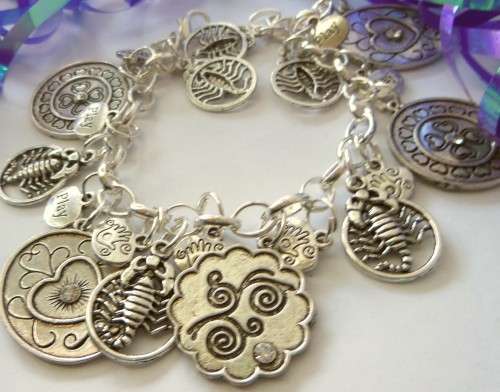 Silvertone Charm Bracelet with Scorpion and floral type Charms