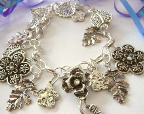 Silvertone Charm Bracelet with Leaf and Flower type Charms