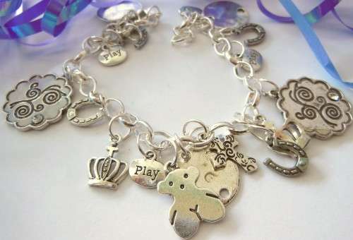Silvertone Charm Bracelet with Horse shoe, Cross and Flower Disk type Charms