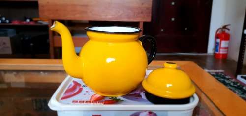 Yellow enamel tea pot