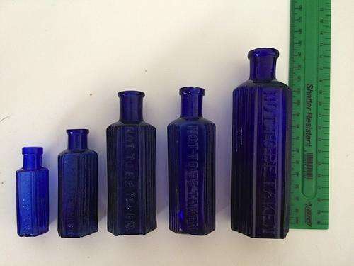 Set of 5 'not to be taken' blue glass bottles