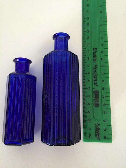 Set of 2 larger blue glass medicine bottles