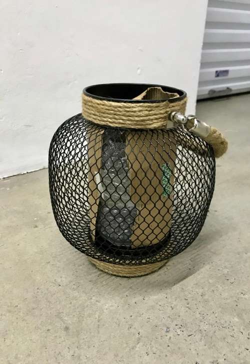 Outdoor lantern with glass candle holder inside