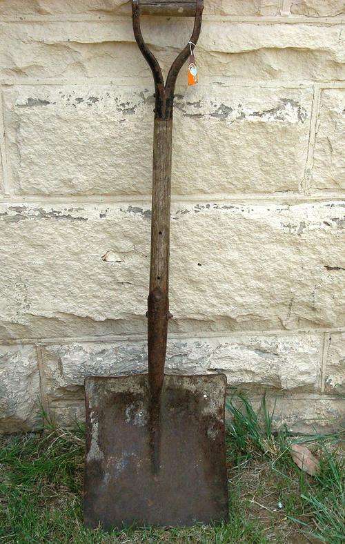 Vintage coal shovel with a wooden handle.