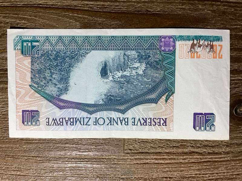 Zimbabwe   *  $20  *  issued 1997  *  some fold marks and mark on top right