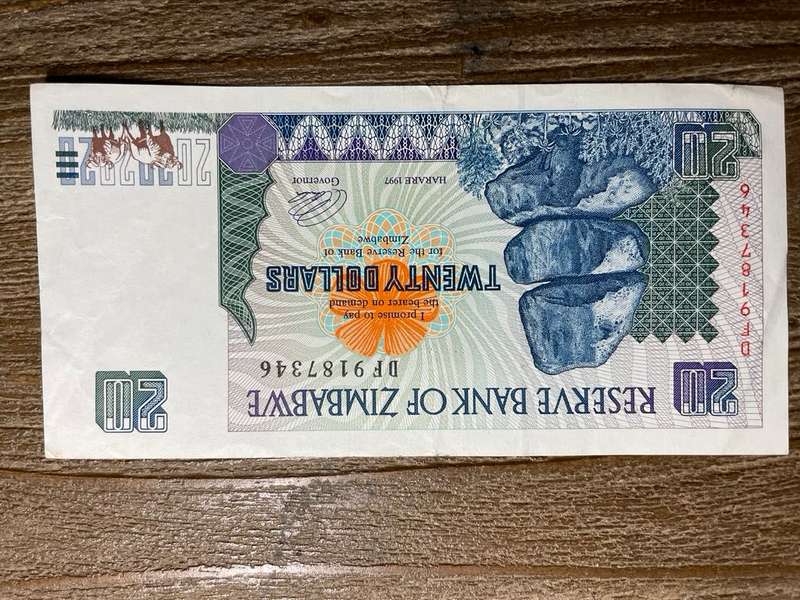 Zimbabwe   *  $20  *  issued 1997  *  some fold marks and mark on top right