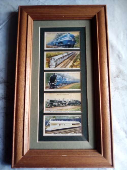 Cigarette cards neatly mounted in smart wooden frames
