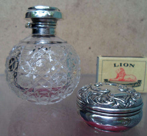 HALLMARKED EMBOSSED SILVER PILL BOX AND SILVER TOP SCENT BOTTLE