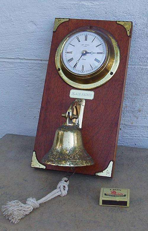 ORNAMENTAL SHIPS CLOCK AND BELL IN SOLID BRASS WITH WOODEN MOUNT