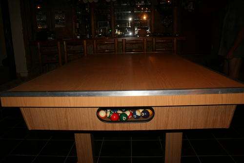 Pool table with wood over top