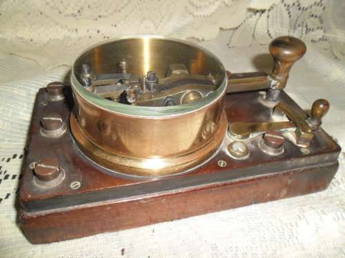 Brass and wood vintage Morse code telegraph key with glass cover