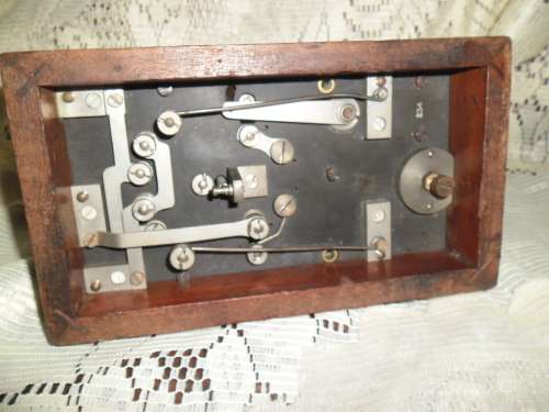 Brass and wood vintage Morse code telegraph key with glass cover