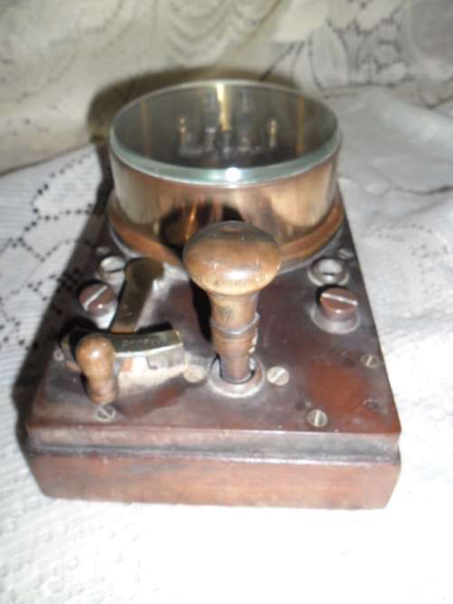 Brass and wood vintage Morse code telegraph key with glass cover