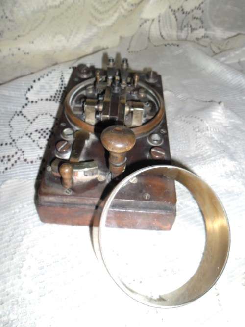 Brass and wood vintage Morse code telegraph key with glass cover