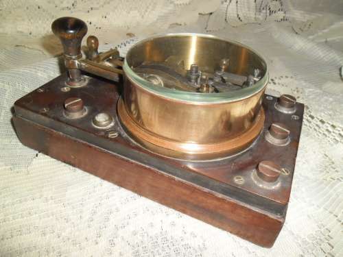 Brass and wood vintage Morse code telegraph key with glass cover