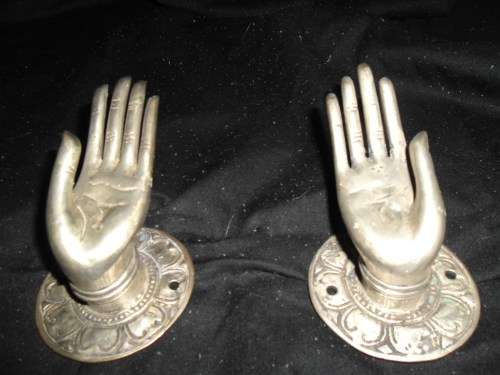 A pair of quirky pewter-looking  hand shaped door / drawer handles.