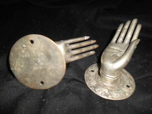 A pair of quirky pewter-looking  hand shaped door / drawer handles.