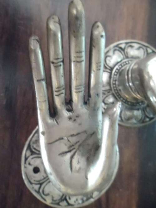 A pair of quirky pewter-looking  hand shaped door / drawer handles.
