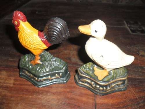Pair of petite cast metal doorstops. Duck and chicken