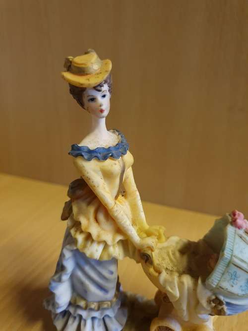 Female Figurine with Pram & Baby