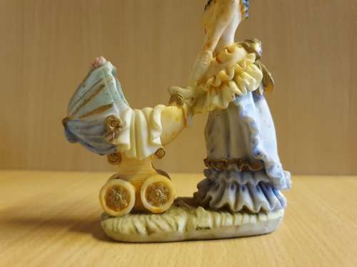 Female Figurine with Pram & Baby