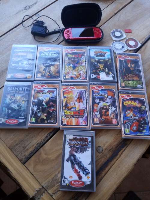 Sony PSP Red with 14 games and a 4GB memory card.