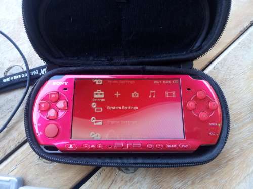 Sony PSP Red with 14 games and a 4GB memory card.