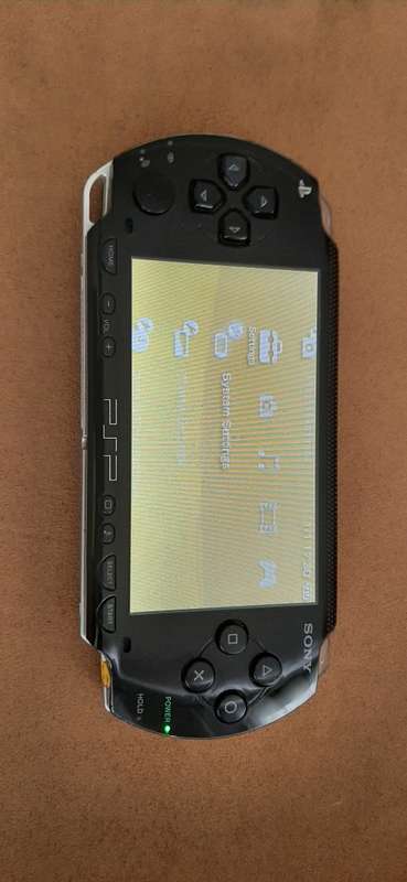 PSP Black console ( works 100% has a dirt speck in the screen)