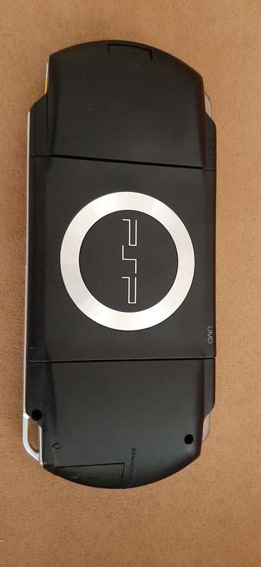 PSP Black console ( works 100% has a dirt speck in the screen)