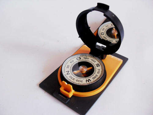 Vintage Soviet compass, orange, black plastic case.