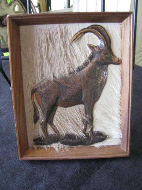 A GORGEOUS WALLHANGING OF A BUCK WITH MAGNIFICENT HORNS ON A BACKDROP OF BUCKSKIN