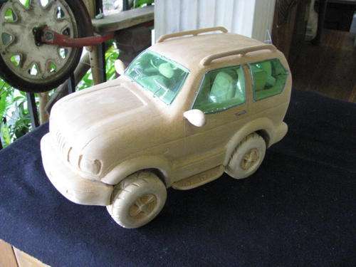 A CARVED WOODEN CAR...ATTENTION TO DETAIL IS INCREDIBLE.. WHEELS MOVE!!! GREAT GIFT@CRRAAZY R1 START