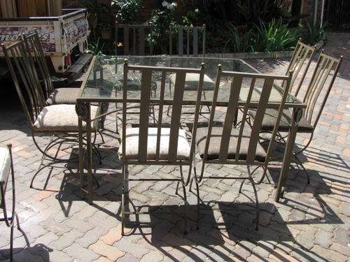 A HIGH QUALITY RETRO GLASS AND STEEL TABLE WITH 8 CHAIRS.PERFECT FOR  THE PATIO/ DINING AREA reduced